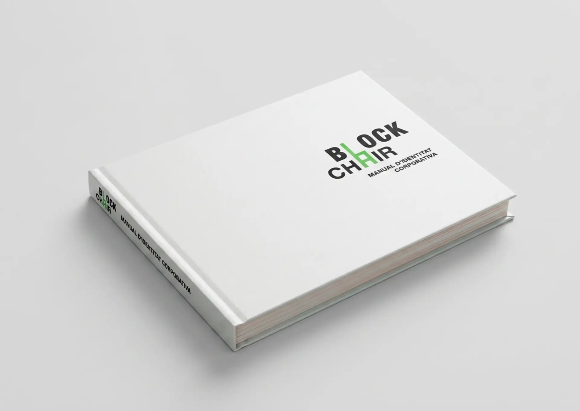 Perspective view of a closed book with a white hard cover and visible spine against a neutral background. The cover displays the "Block Chair" logo with green details and the subtitle "Corporate Identity Manual".